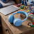 Children’s blue wireless headphones on wooden bedside table