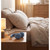 Blue wireless headphones on bedside table in softly lit modern bedroom