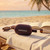 Red portable Bluetooth speaker on sun lounger by the sea, holiday setting