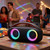 Portable wireless speaker with colourful LED lights on a table at a party