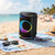 Black wireless party speaker with circular LED lights, front-facing view