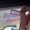 Spot check service record card holder, attached to inside corner of car windshield, shown with service record card inserted