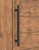 Pro-Line Series: Fluted Ladder Pull Handle - Back-to-Back, Matte Black Powder Coated Finish, 316 Grade Stainless Steel Alloy mockup on wood door