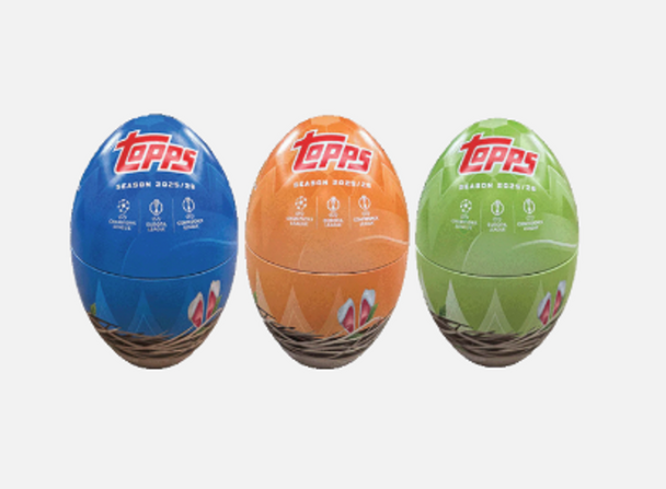 Colorful 2025/26 Topps UEFA Champions League Easter tins featuring egg-shaped collectible containers in blue, orange, and green with UEFA Champions League soccer trading cards inside.