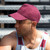 Man wearing a red personalised 5 panel cap with seamless front panel and curved peak, custom logo printed on breathable brushed cotton.
