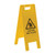 Yellow "Caution Wet Floor" A-frame sign with a warning symbol of a person slipping. Used to alert people of wet or slippery floors in public spaces, enhancing safety and preventing accidents.
