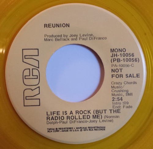 Reunion (3) - Life Is A Rock (But The Radio Rolled Me) (7", Single, Mono, Promo, Yel)