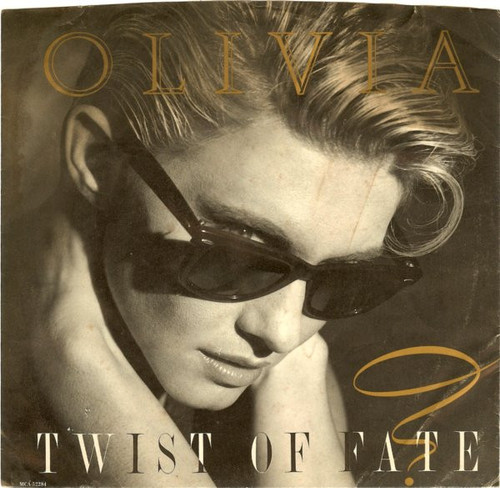 Olivia* - Twist Of Fate (7", Single, Glo)