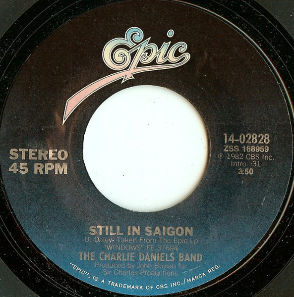 The Charlie Daniels Band - Still In Saigon / Blowing Along With The Wind (7", Single, Styrene, Pit)