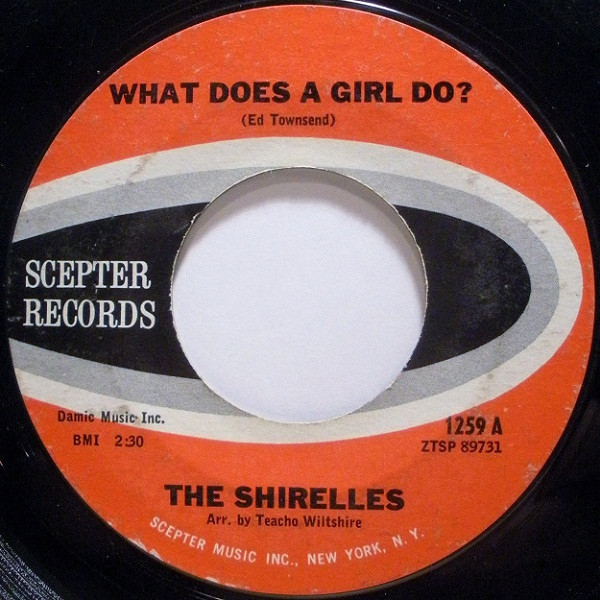 The Shirelles - What Does A Girl Do? (7", Single)