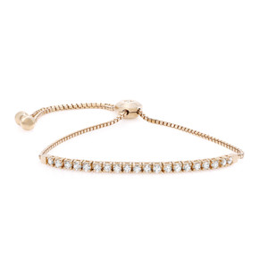 An image of a Rachel Koen women's bracelet with diamonds, positioned centrally against a white background. The bracelet features a single row of sparkling round cut diamonds set in a yellow gold band, with a hexagonal gold clasp and adjustable chain visible. The view is a close-up, focusing on the diamonds and clasp, giving a clear representation of the bracelet's design and quality. The perspective is a slight top-down angle, allowing the diamonds to catch the light and display their brilliance.
