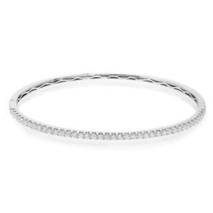 An image of a Rachel Koen women's bracelet with round cut diamonds, displayed in a frontal, slightly angled view to show both the outer smooth surface and the inner row of diamonds. The bracelet is centered and shown up close against a white background, capturing the brilliance of the diamonds and the polished finish of the white gold band.