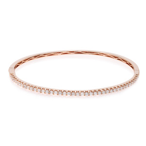 An image of a Rachel Koen women's bracelet with diamonds, displayed in a close-up, front-facing view against a white background. The bracelet is rose gold with a row of sparkling round cut diamonds set along the top half, while the bottom half showcases a smooth, polished surface. The bracelet is positioned horizontally and centered in the frame, offering a clear view of its elegant design and luxurious gemstones.