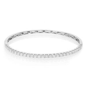 An image of a Rachel Koen women's bracelet with round cut diamonds in white gold, showcased in a straight-on view. The bracelet is positioned horizontally across the center of the frame against a white background. The diamonds are set along the top half of the bracelet, sparkling against the light, while the bottom half reveals intricate metalwork. The bracelet appears to be in close proximity, providing a clear view of the diamonds and design details.