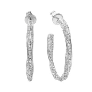 An image of a pair of Rachel Koen brand women's hoop earrings with diamonds. The earrings are positioned vertically side by side in the center of the frame with a close-up view, showcasing the intricate setting of the round cut diamonds along the outer curve in white gold. Each earring has a post-back closure visible at the top, with the left earring slightly angled to display the inner curve and the right earring facing directly forward to emphasize the diamond details. The background is a neutral white, providing a high contrast to the sparkling jewelry.