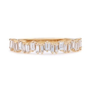 An image of a Rachel Koen women's ring with diamonds, showcasing a close frontal and slightly angled view. The ring features a series of vertically set, baguette cut diamonds encircling the yellow gold band. The perspective offers a clear view of the diamonds' facets and the ring's elegant design. The image is taken from a middle distance, allowing for detailed inspection of the gemstones and craftsmanship.
