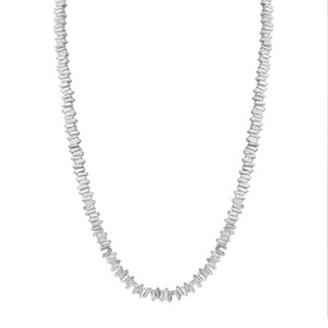 An image of a Rachel Koen women's necklace with diamonds displayed against a white background. The necklace is laid out in a slight curve mimicking the natural drape around a neck. It features numerous baguette cut diamonds set in white gold in a continuous line, positioned to reflect light and sparkle. The angle of the photograph is a straight-on view, with the necklace centered and occupying most of the frame, providing a clear and detailed look at the craftsmanship and design of the piece.