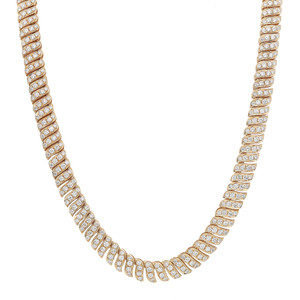 An image of a Rachel Koen brand women's necklace with round cut diamonds, laid out against a white background. The necklace is positioned in a slight U-curve, showcasing the brilliance and design from a front-facing angle. The diamonds are set in a repeating pattern along the entire length of the yellow gold necklace, which is visible in its entirety, suggesting a close to medium distance from the viewer. Each link features multiple diamonds within a yellow gold setting, reflecting light and creating a sparkling effect.