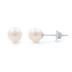 An image of a pair of Rachel Koen pearl stud earrings for women, isolated on a white background. The earrings are positioned side by side, with the left earring facing the camera showing the pearl front, and the right earring turned at a slight angle to display the post and backing. The pearls have a soft luster and a creamy hue in white gold. The photograph is taken from a close-up, front-facing angle, capturing the elegant simplicity of the design.