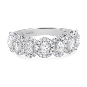 An image of a Rachel Koen women's ring with diamonds, displayed in a close-up, frontal view. The ring features a series of round-cut diamonds encircled by halos of smaller diamonds, set in a polished 18K white gold band. The design is intricate and the diamonds catch the light at various angles, suggesting brilliance and luxury.