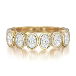 An image of a Rachel Koen brand women's ring with diamonds, displayed in a close-up view against a white background. The ring is positioned horizontally in the center of the frame. It features a polished yellow gold band encrusted with round cut diamonds, each encased in a gold bezel setting. The diamonds are aligned in a row, and the perspective is head-on, allowing clear visibility of the ring's design and the sparkling facets of the diamonds. The image is taken from a slight elevation, showcasing the ring's profile and the circular cut of each diamond. The distance is such that the ring occupies the majority of the image, providing a detailed view of the craftsmanship.