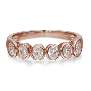 An image of a Rachel Koen brand women's ring with diamonds. The ring is showcased in a close-up, frontal view against a white background. It features a shiny rose gold band holding five oval cut diamonds, each encased in a rose gold bezel setting. The diamonds are evenly spaced, and the image is taken at an angle that focuses on the sparkle of the stones and the details of the settings.