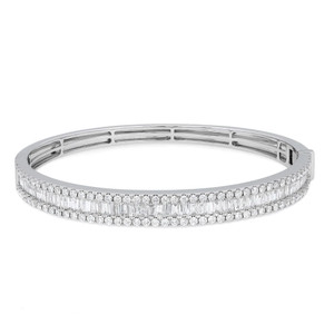An image of a Rachel Koen women's bracelet with diamonds, displayed frontally at a mid-range distance on a white background. The bracelet is positioned horizontally in the center of the frame, showcasing a full view of the diamond-encrusted bracelet that glitters with round and baguette-cut stones set in a polished white gold metal. The clasp is visible on the right side, indicating the bracelet's functionality and elegance.
