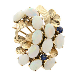 Front view of the Estate cocktail ring with oval shaped white opal stones and round cut blue sapphires in prong setting with stripped yellow gold leaf designs in yellow gold mounting