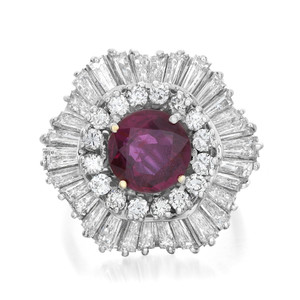 Front view of the cocktail ring showing prong set round cut ruby in the center accented with round cut and baguette cut diamonds in white gold