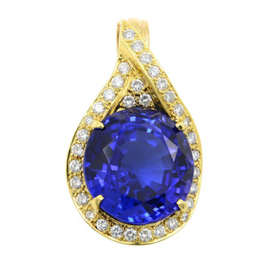 Front view of the pendant with center prong set oval cut blue tanzanite accented with pave and prong set round cut diamonds in yellow gold without chain  