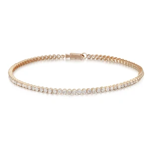 An image of a Rachel Koen unisex adult tennis bracelet with diamonds. The bracelet is positioned centrally and horizontally against a white background. It features a full view showing a row of sparkling round cut diamonds set in yellow gold, capturing the light at various angles to emphasize their brilliance. The clasp of the bracelet is visible on the left side, and the entire piece is in sharp focus, allowing for detailed observation from a medium distance.