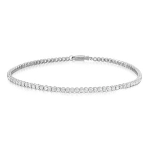 An image of a Rachel Koen brand unisex adult tennis bracelet with diamonds, presented in a close-up, frontal view on a white background. The bracelet forms a nearly complete circle with the front facing upwards, showcasing a continuous row of sparkling diamonds set in white gold band. The clasp is visible at the top, slightly off-center, indicating the opening of the bracelet. The diamonds are arranged in a single line, capturing the light and emphasizing their brilliance. The image is taken from a distance that allows the entire bracelet to be visible, focusing on the detail and craftsmanship of the piece.
