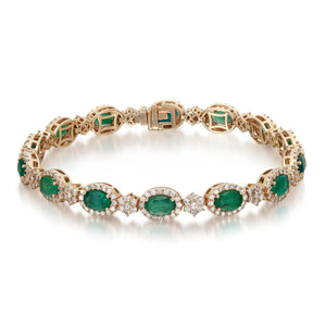 An image of a Rachel Koen women's bracelet, displaying a front view on a neutral background. The bracelet is crafted from 14k yellow gold and features a series of 14 prong-set oval emeralds, each framed by sparkling diamonds. The emeralds have a rich green color and are interspersed with intricate gold links, enhancing the bracelet's elegance. The decorative elements are captured in sharp detail, showcasing the luxurious and refined design of the piece. The image is taken from a close, straight-on angle, allowing for a clear view of the gemstone settings and the overall craftsmanship.