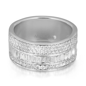 An image of a luxurious Messika women's Liz Baguette and round diamond band 18k white gold ring, presented in a close-up, side view. The ring features a band with multiple rows of sparkling diamonds - the top and bottom rows consist of round-cut stones, while the center row is adorned with larger, emerald-cut diamonds. The brand's name is engraved on the polished metal surface, visible on the upper part of the ring. The image is taken at a slight angle, showcasing the ring's intricate details and the brilliance of the diamonds.