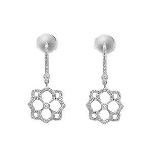 An image of a pair of Messika women's Eden Dormeuses drop earrings with diamonds, displayed against a white background. The earrings are shown in a frontal view, positioned symmetrically side by side, at a close-up distance that highlights their intricate design. Each earring features a sparkling diamond-studded drop connecting to a flower-shaped diamond-encrusted pendant, all set in a shiny white gold.