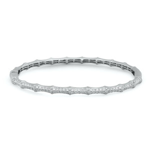 An image of a Rachel Koen women's bangle bracelet with diamonds, showcasing a close-up, frontal view on a white background. The bracelet is positioned horizontally across the frame at a slight angle, allowing for a clear view of the sparkling pave set round cut diamonds embedded along the top half, contrasted against the polished white gold. The distance from the camera ensures the entire circumference of the bracelet is visible, highlighting its elegant design and craftsmanship.