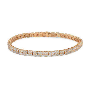 An image of a Rachel Koen women's tennis bracelet with diamonds, displayed against a white background. The bracelet is shown in a straight line from a top-down view, allowing the entire length of the piece to be visible. It is positioned horizontally across the frame, with the clasp located slightly to the right of the center. The round cut diamonds are set in a symmetrical pattern, reflecting light and showcasing their brilliance. The yellow gold metal of the bracelet contrasts with the sparkling diamonds, and the distance from the camera provides a clear and detailed view of the entire bracelet.