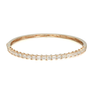 An image of a Rachel Koen women's bangle bracelet with diamonds, presented in a close-up front view on a neutral background. The bracelet displays a row of sparkling emerald cut diamonds set in a yellow  gold bracelet, positioned horizontally across the frame with a slight perspective angle that showcases its circular shape and intricate detailing.