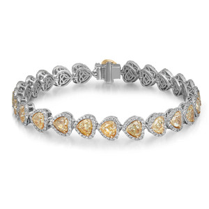 An image of a Rachel Koen women's bracelet with diamonds, displayed against a white background. The bracelet is shown in a straight line from a top view angle, allowing the intricate details and the sparkle of the diamonds to be clearly visible. The design features a series of white gold links, each containing a heart shaped, yellow diamond surrounded by smaller white diamonds in halo setting, all set in a polished white gold frame. The clasp is visible to the right and blends seamlessly with the bracelet's design. The image is taken from a close distance, ensuring the diamonds' brilliance and the bracelet's craftsmanship are in focus.