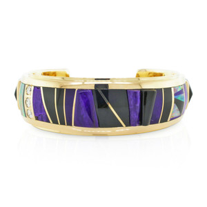 An image of a Black Jade Fire Opal Raoul Sosa women's bracelet with diamonds, positioned centrally and viewed from a front angle at close distance. The bracelet features a 14k yellow gold band with inlaid black jade gemstones and opal fragments separated by thin yellow gold lines, accented with small, sparkling diamonds along one edge. The background is white, highlighting the jewelry's colors and shine.