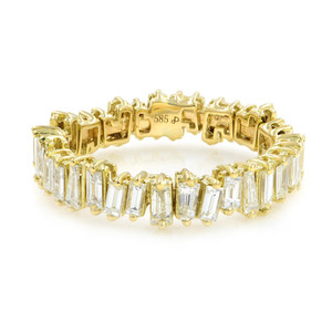 An image of a Rachel Koen women's ring with diamonds, displayed at a slight angle to show the top and side views, with a close-up perspective. The ring features a series of baguette cut diamonds set in a yellow gold band, encircling the entire piece. The intricate gold setting is visible, providing a contrast to the sparkling diamonds. The hallmark "585" is also visible, indicating the gold quality.