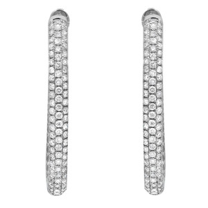 An image of a pair of Rachel Koen brand women's earrings with diamonds. The earrings are positioned vertically, side by side, and shown from a front-facing angle. They appear as slender, curved bars fully encrusted with small, round-cut diamonds that sparkle against a white background in white gold. The image is a close-up, providing a clear view of the earrings' intricate details.