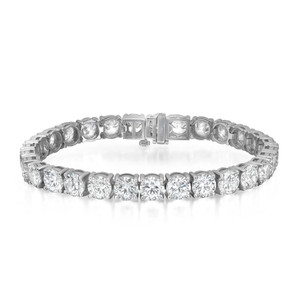An image of a unisex adult Rachel Koen bracelet with lab grown diamonds, displayed in a straight line at a slight angle facing the viewer. The bracelet features a sequence of round cut diamonds set in a reflective white gold bracelet in prong setting, with a secure clasp visible in the middle. The photo is taken from a close distance, with the bracelet occupying the majority of the frame, providing a clear view of the diamond details and craftsmanship.