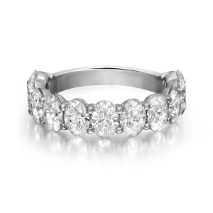 An image of a Rachel Koen brand women's ring with lab grown diamonds, displayed in a close-up front view on a pure white background. The ring features a series of large, oval cut diamonds set in a platinum band, capturing the light from various angles to showcase their brilliance and clarity. The precious stones are mounted on a polished band, visible on either side of the diamonds, which circles around to complete the elegant piece. The image is taken at a distance that allows for the entire circumference of the ring to be visible, highlighting the craftsmanship and luxurious design.
