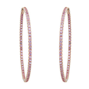 An image of a pair of Rachel Koen women's hoop earrings with pink sapphire gemstones, displayed against a white background. The earrings are positioned vertically and parallel to each other, with an equal distance between them. They are captured from a direct front angle, showcasing the pink sapphire gemstones encrusted along the full length of the hoops inside out in yellow gold. The earrings appear to be complementing the gemstones' color.