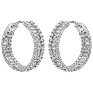 An image of a pair of Rachel Koen brand women's hoop earrings with diamonds, displayed frontally at a close distance. The earrings are hoop-style with multiple rows of small, round-cut diamonds encrusted inside out along their circumferencein white gold, offering a sparkling appearance. Each earring has a secure hinged closure visible at the top. The image is taken at eye level with the earrings positioned parallel to the camera, presenting a clear and detailed view of their design and diamond placement.