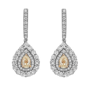 An image of a pair of Rachel Koen diamond earrings for women, displayed frontally at an equal distance from the viewer, with a clear view of the intricate design. Each earring features a pear-shaped central yellow diamond, encased in a halo of smaller round cut diamonds, and suspended from a straight line of diamonds, all set in a white gold metal. The earrings are symmetrically positioned side by side.