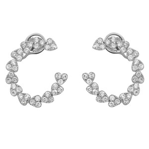 An image of a pair of Rachel Koen women's hoop earrings with diamonds. The earrings are displayed frontally and symmetrically against a white background, with each earring forming a semi-circle shape. They are embellished with multiple heart-shaped mountings with round cut diamonds, all of which are set in a way that maximizes their sparkle. The photo is taken from a medium distance, providing a clear view of the earrings' design and the shine of the diamonds.