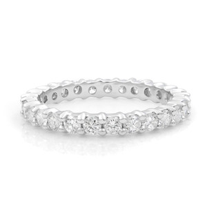 An image of a Salvini women's eternity wedding band ring with diamonds, displayed in a close-up side view with an angle showing the top and slightly the inner side of the band. The ring highlights its polished 18k white gold metal and the multiple round-cut diamonds encrusted in a prong setting along the top half of the band. The distance is close enough to show the brilliance of the diamonds and the detailed craftsmanship of the ring.  The ring is pre-owned in great condition. 
