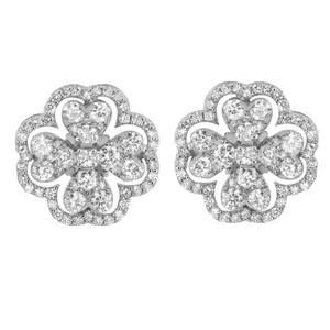 An image of a pair of Rachel Koen women's earrings with diamonds, displayed frontally and centered. The earrings have a flower-like design with sparkling diamonds set in a symmetrical pattern. Each earring features a diamond at the center surrounded by diamonds forming petal shapes. The photo shows the earrings up close, providing a clear view of the intricate details and the reflective qualities of the diamonds.